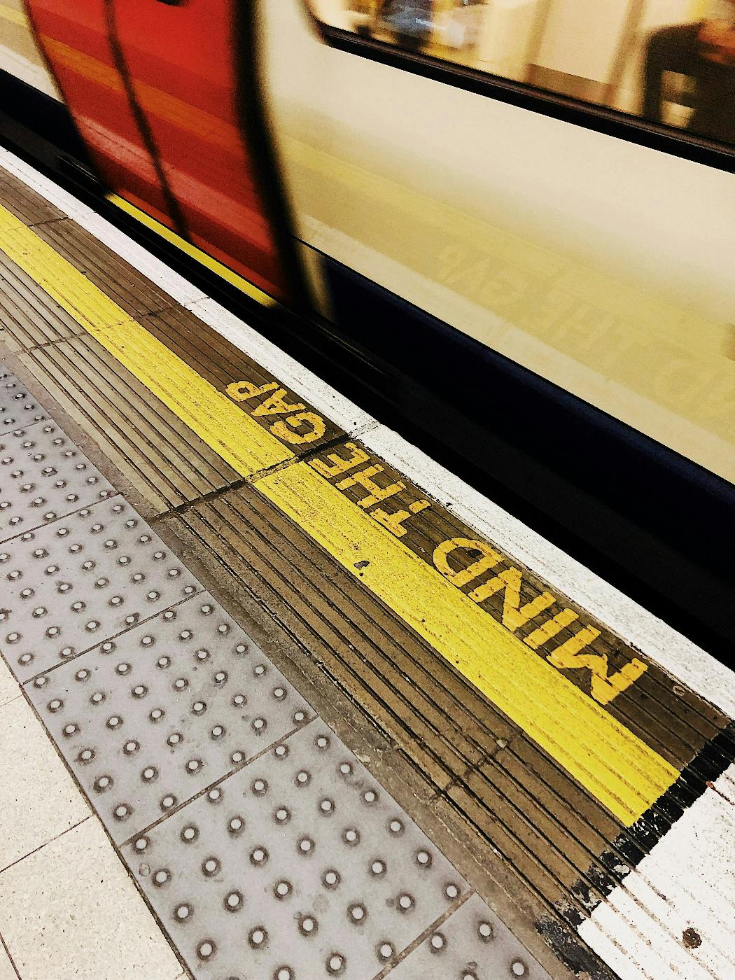 Mind The gap notice eon the floor of a subway platform