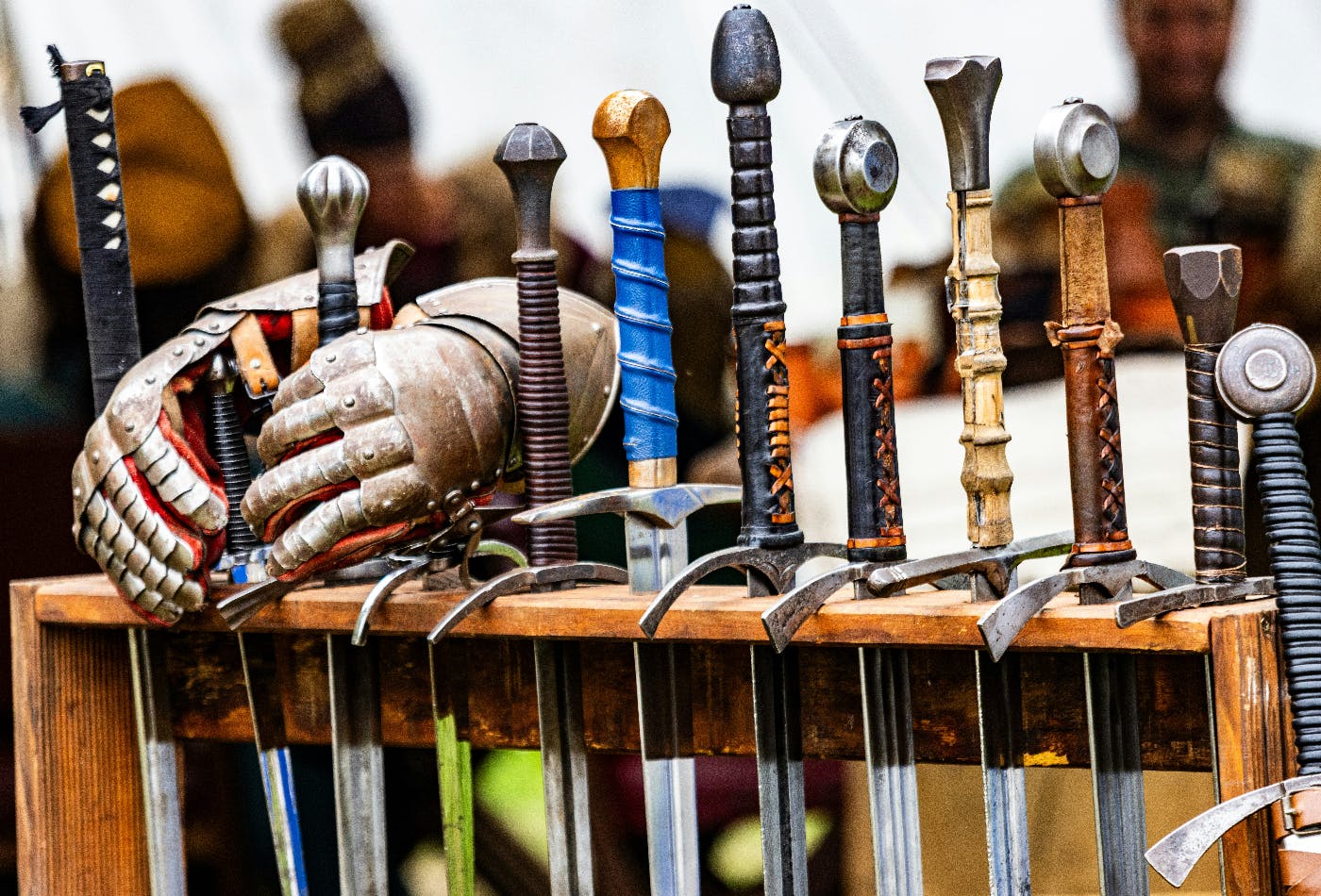 A rack of 11 swords and a pair of armored gloves