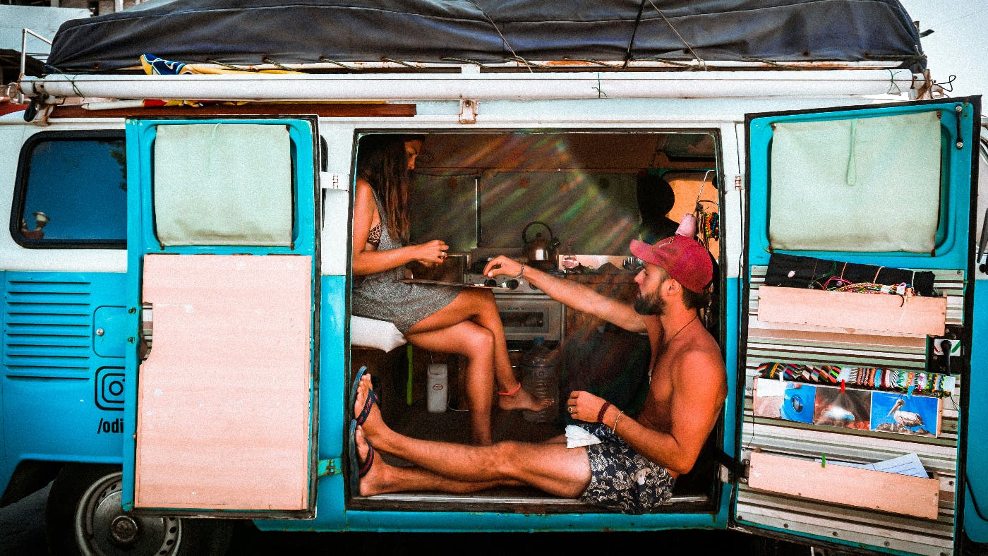 A man and woman in a VW Microbus