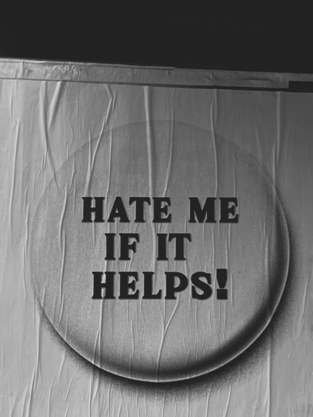 A banner of a button that reads: Hate Me If It Helps