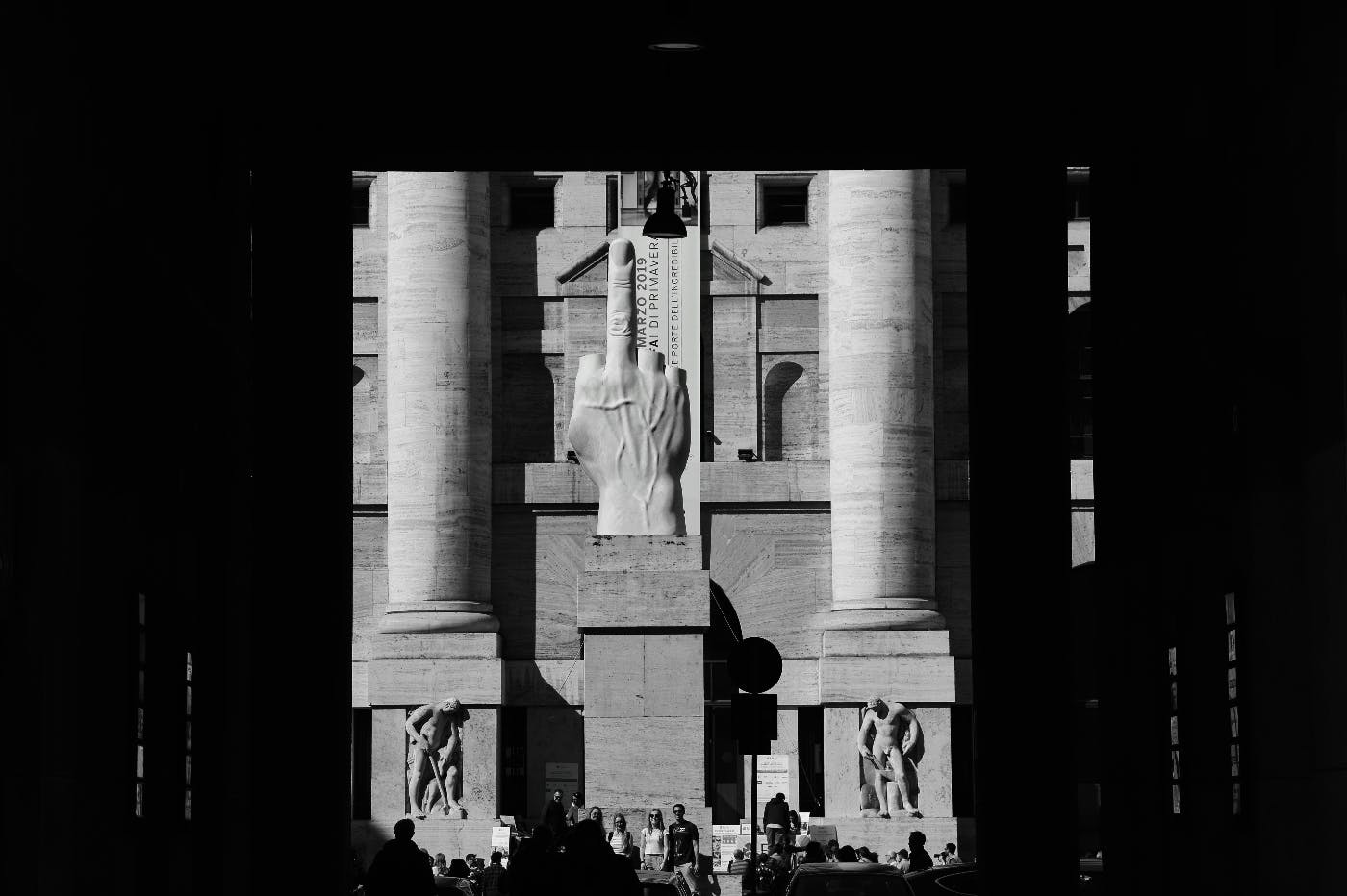 A giant hand on a column giving the middle finger.