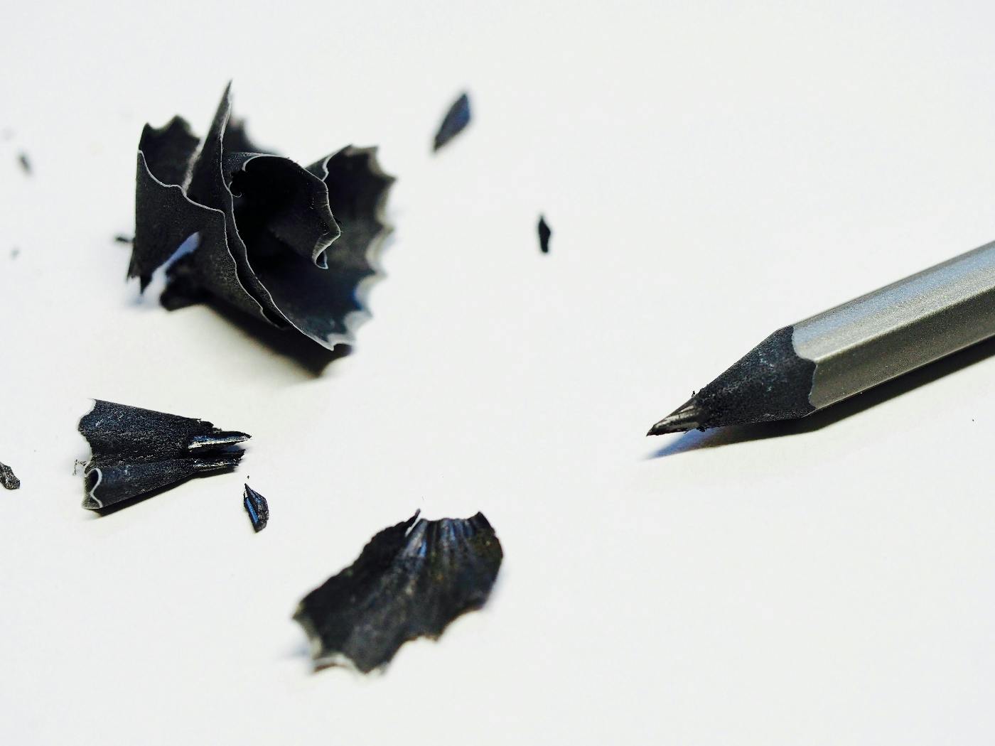 A black and white image of a sharpened pencil and shavings