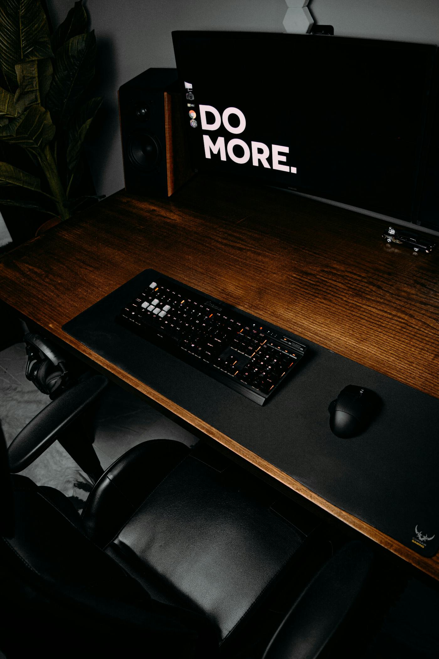 A desk with a monitor that reads Do More.