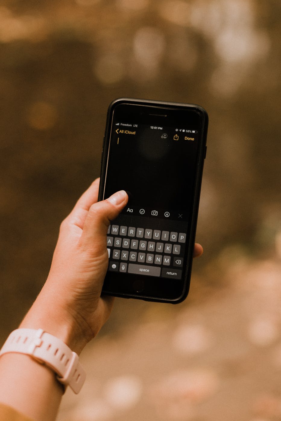 A hand holding a smartphone