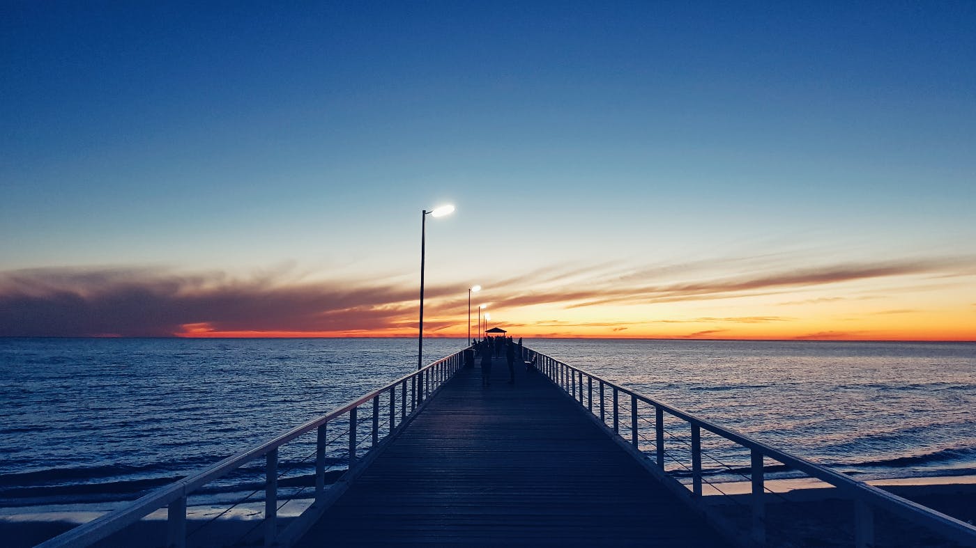A pier stretching onff into the sunset