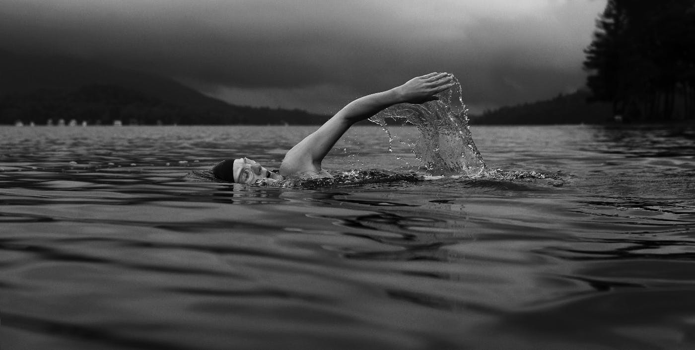 A man swimming in a lake