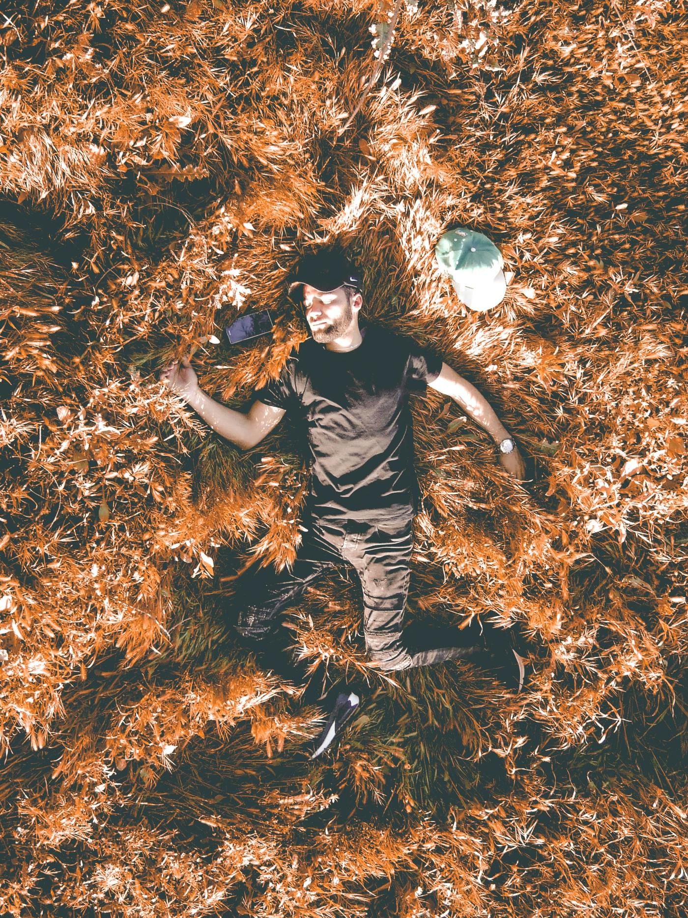 A man laying in a field of grass.