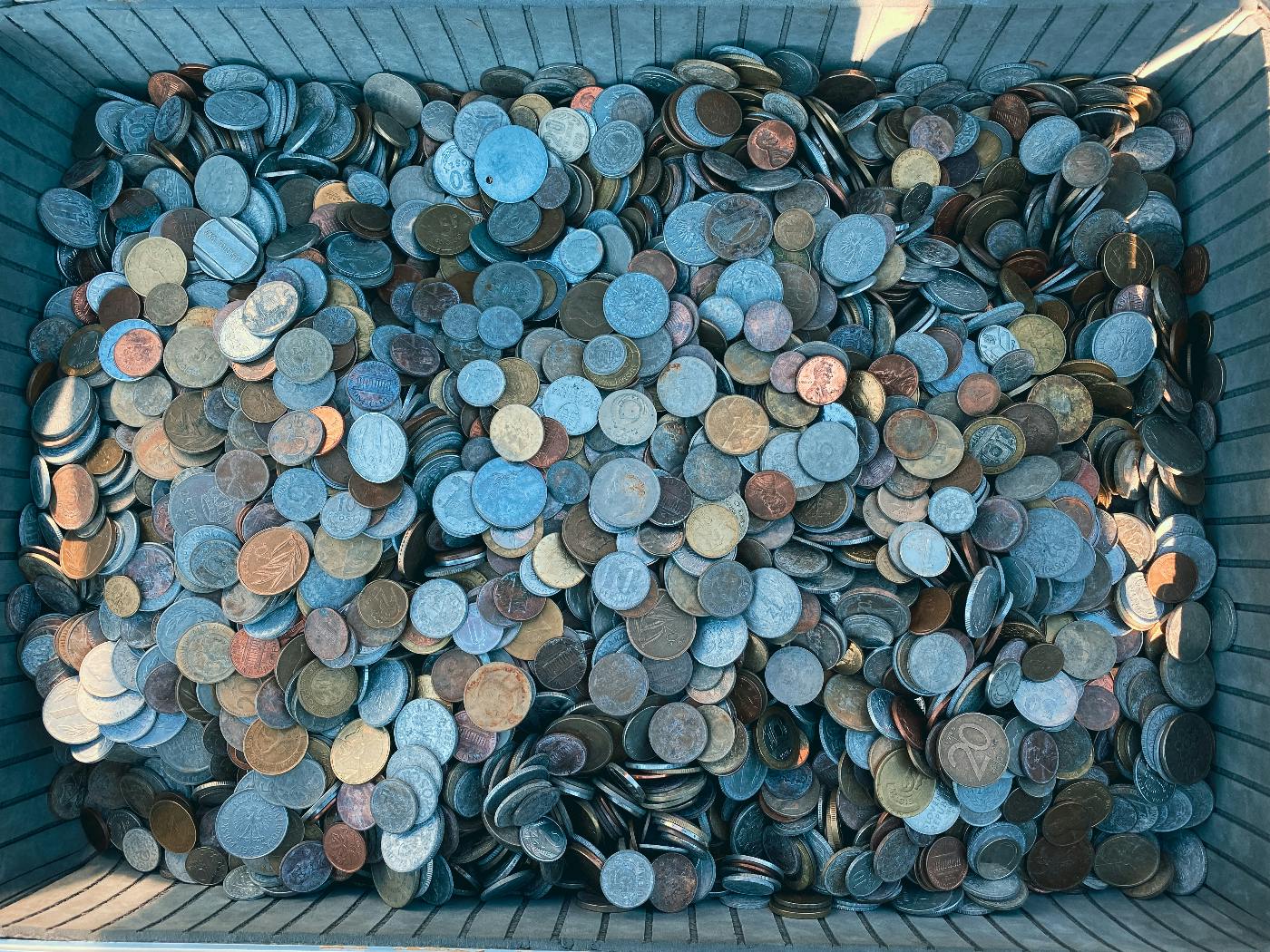 A box full of thousands of different coins