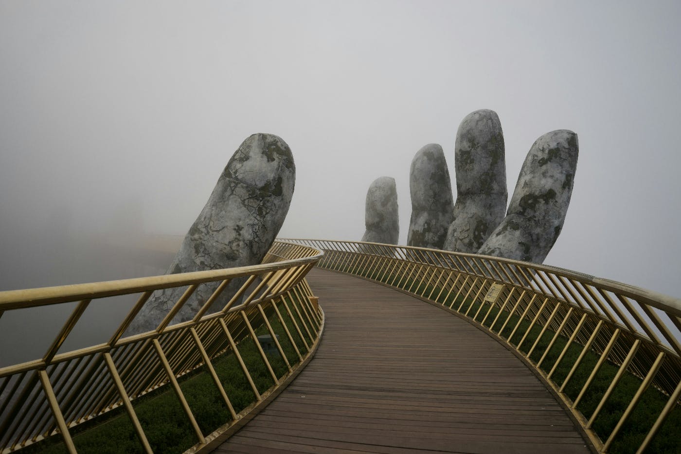 The  curved bridge seemingly supported by a giant hand at the Ba Na Hill Mountain Resorts Da Nang
