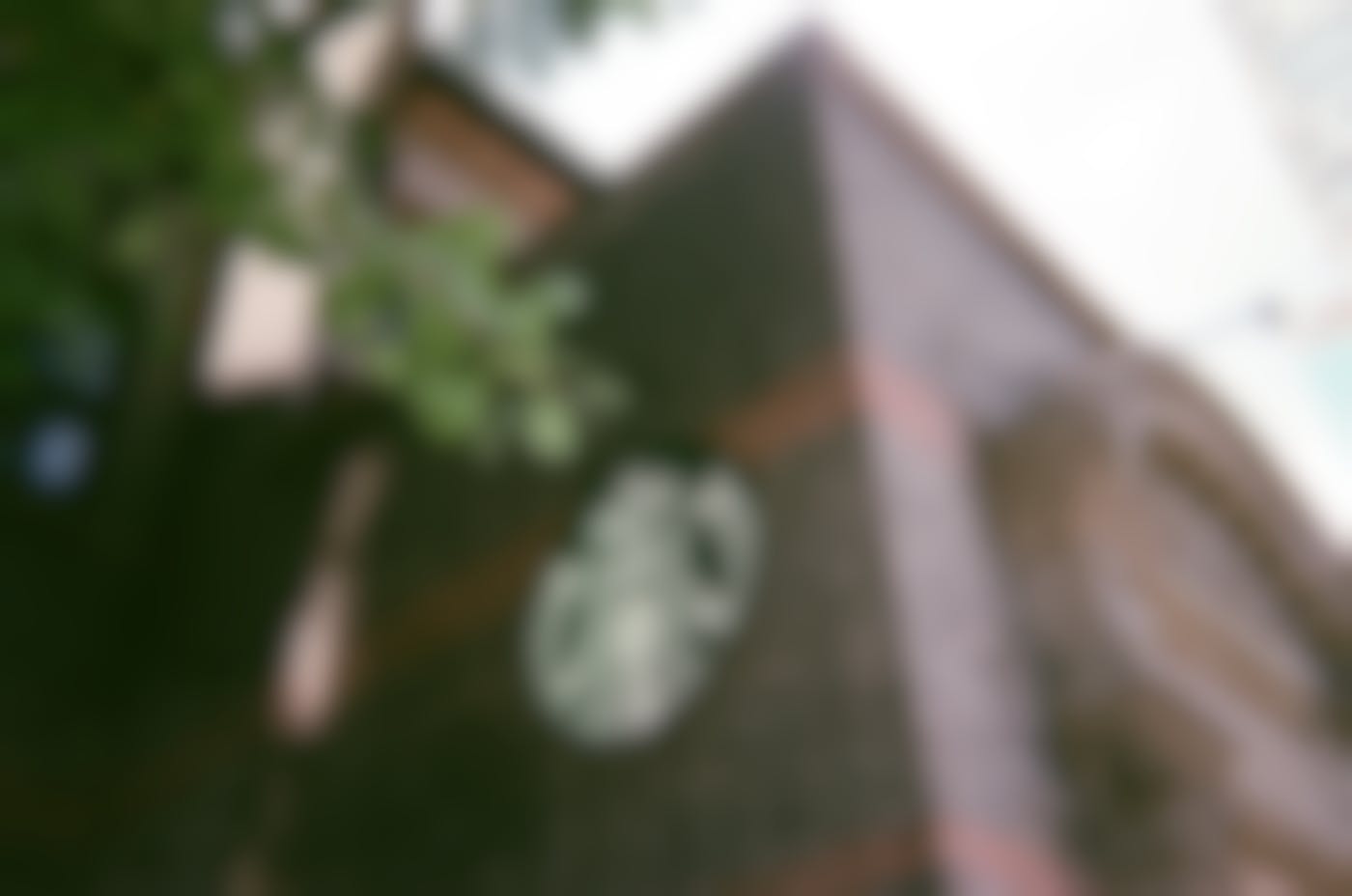 A brick building with a Starbucks Logo n the side