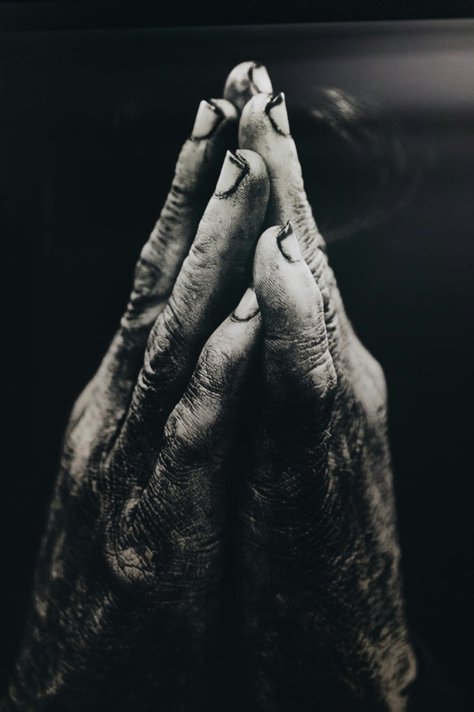 Dusty hands held in prayer