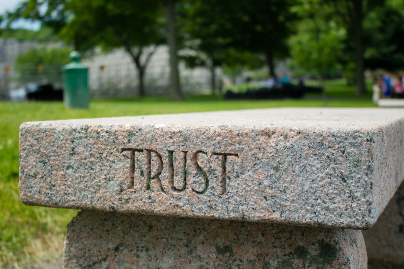 A stone bench with TRUST engraved on the edge