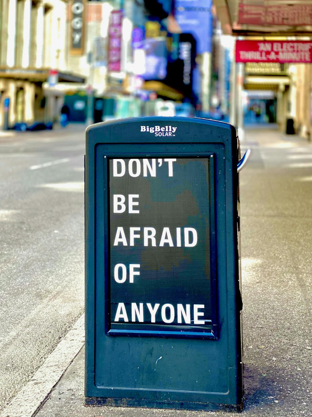 A street sign reading Don't Be Afraid of Anyone