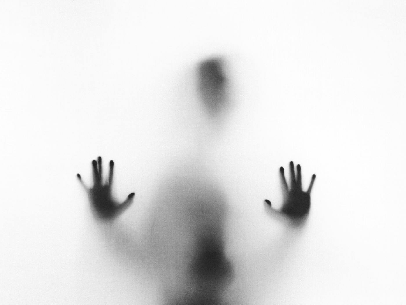 A person behind fogged glass