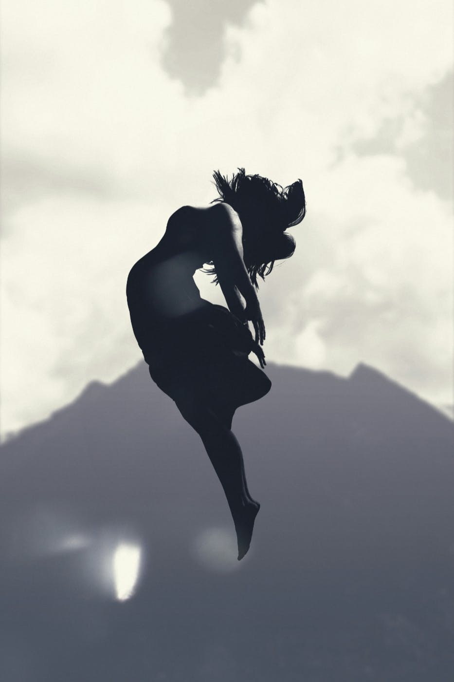 Silhouette of a woman leaping into the air
