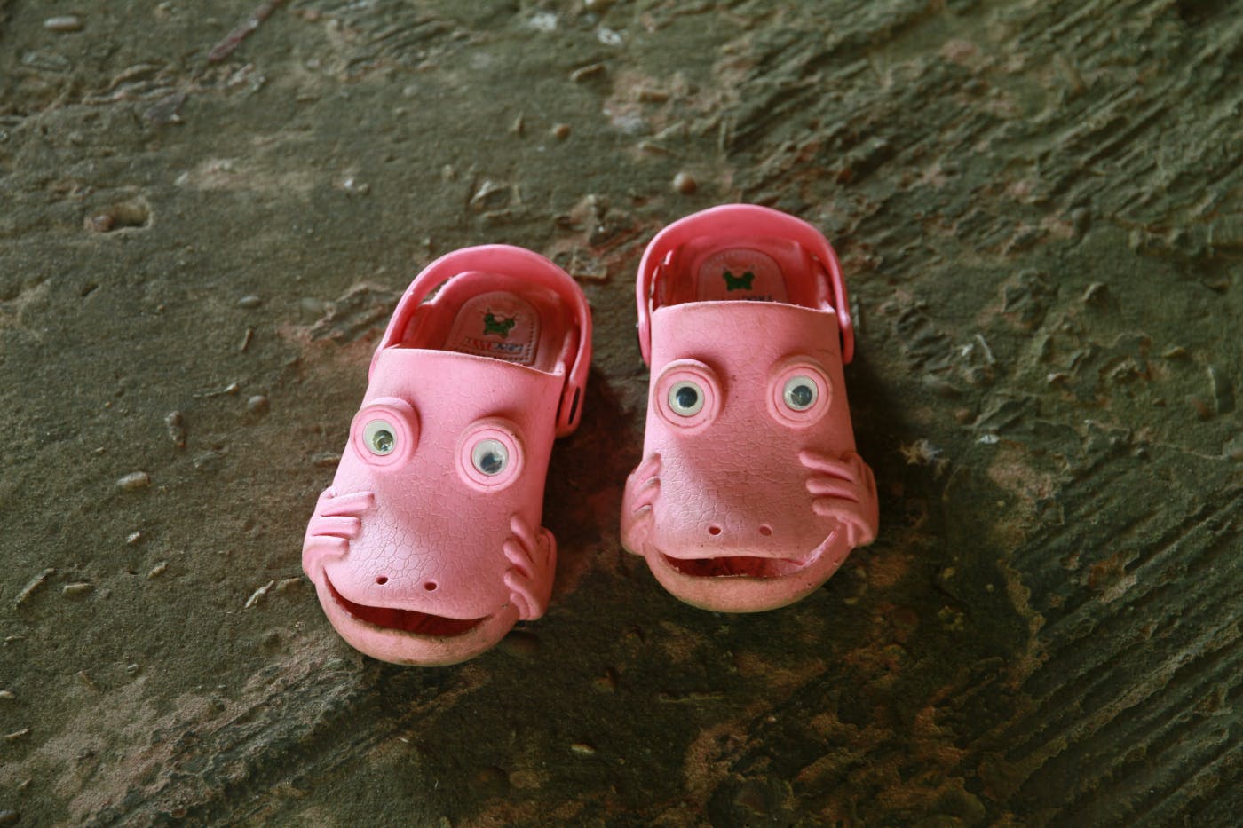 Pink rubber clogs with eyes and smiles