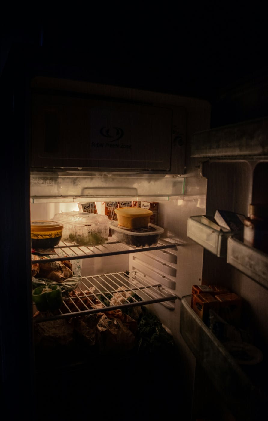 An open, messy fridge