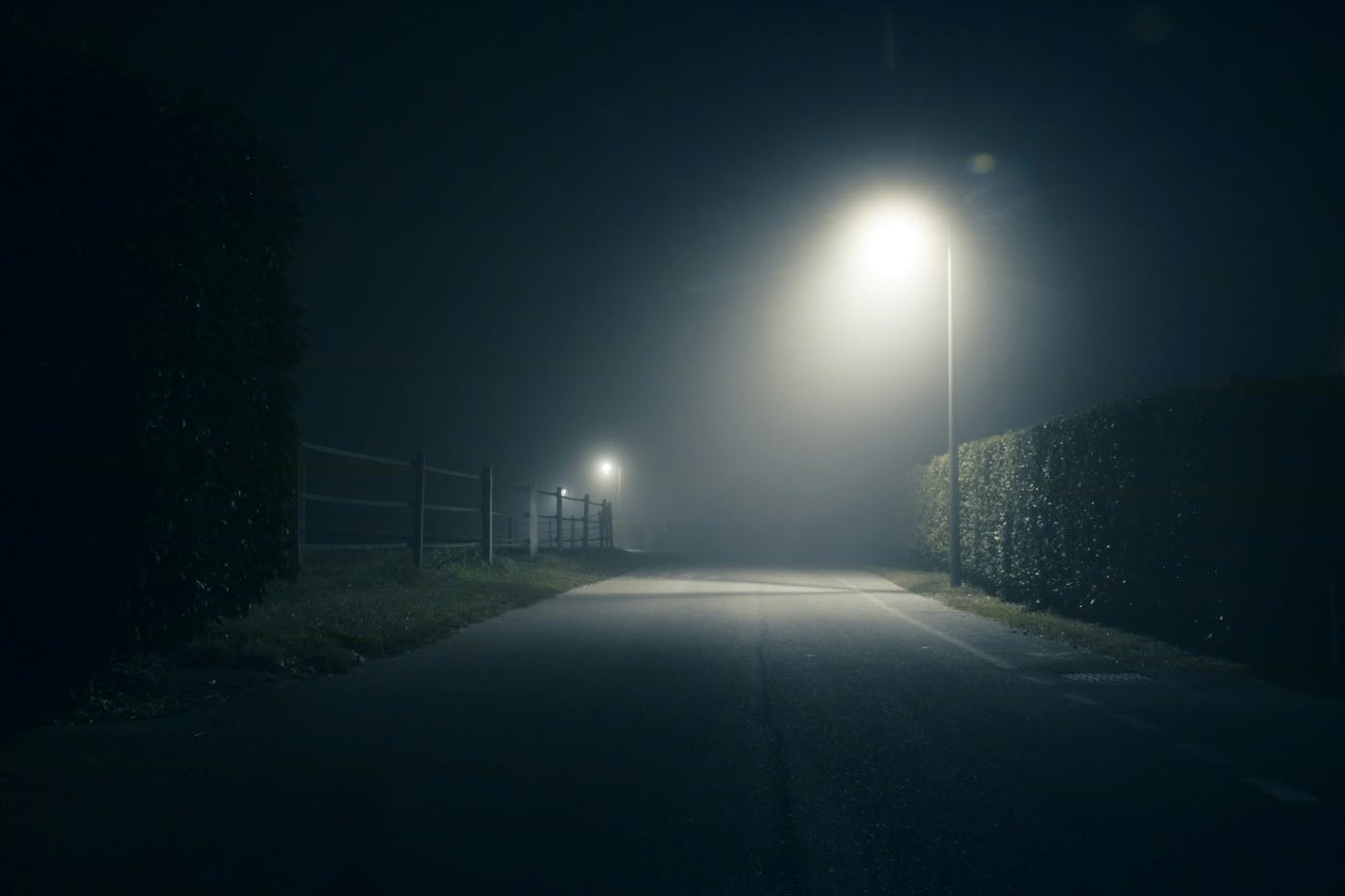 A street dimly lit by one street lamp