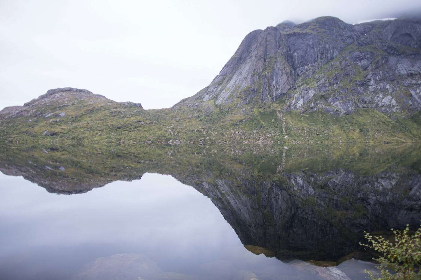 A island perfectly reflected in the still water around it