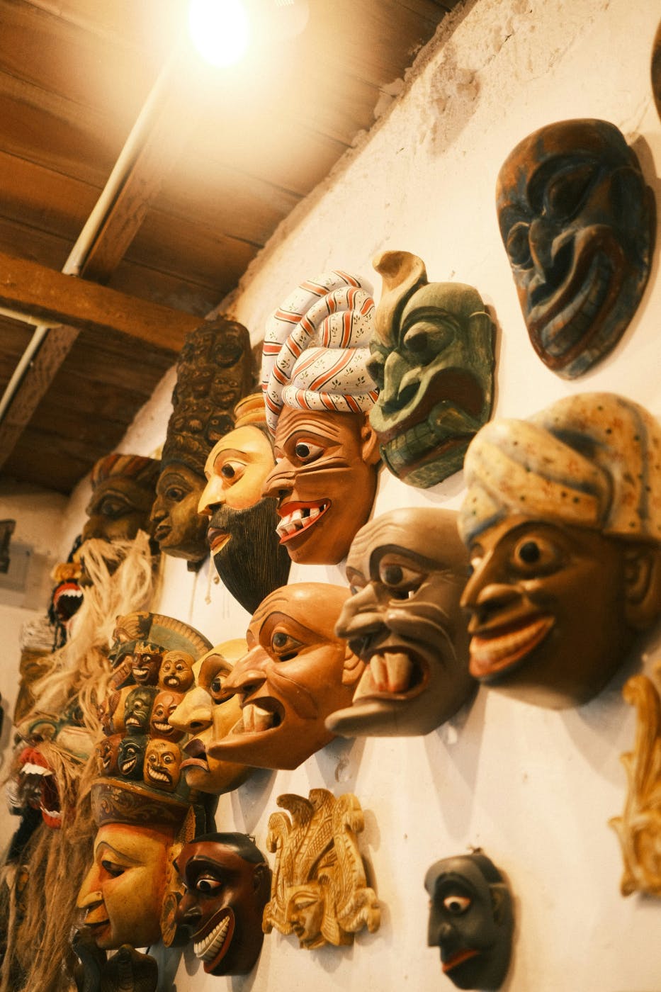 Many tribal masks on a wall