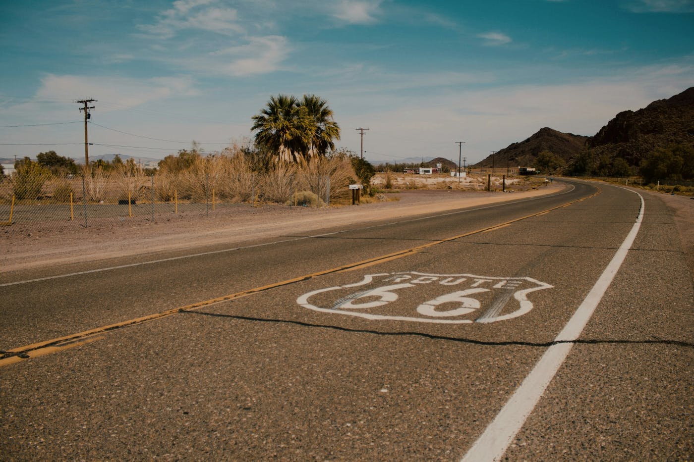 A stretch of road with the Route 66 emblem painted on it