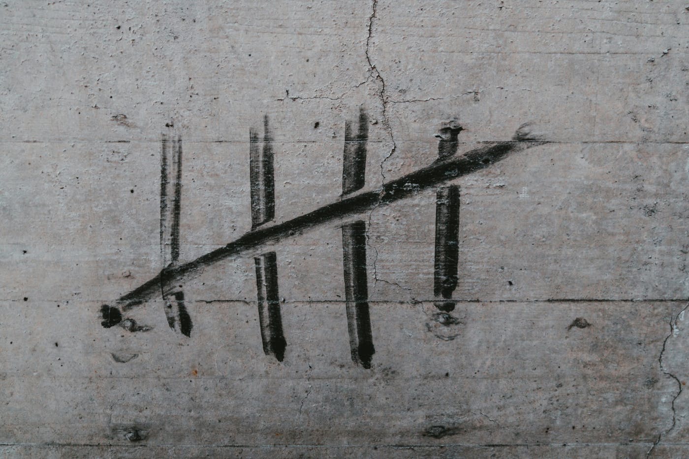 A tally mark on a concrete wall
