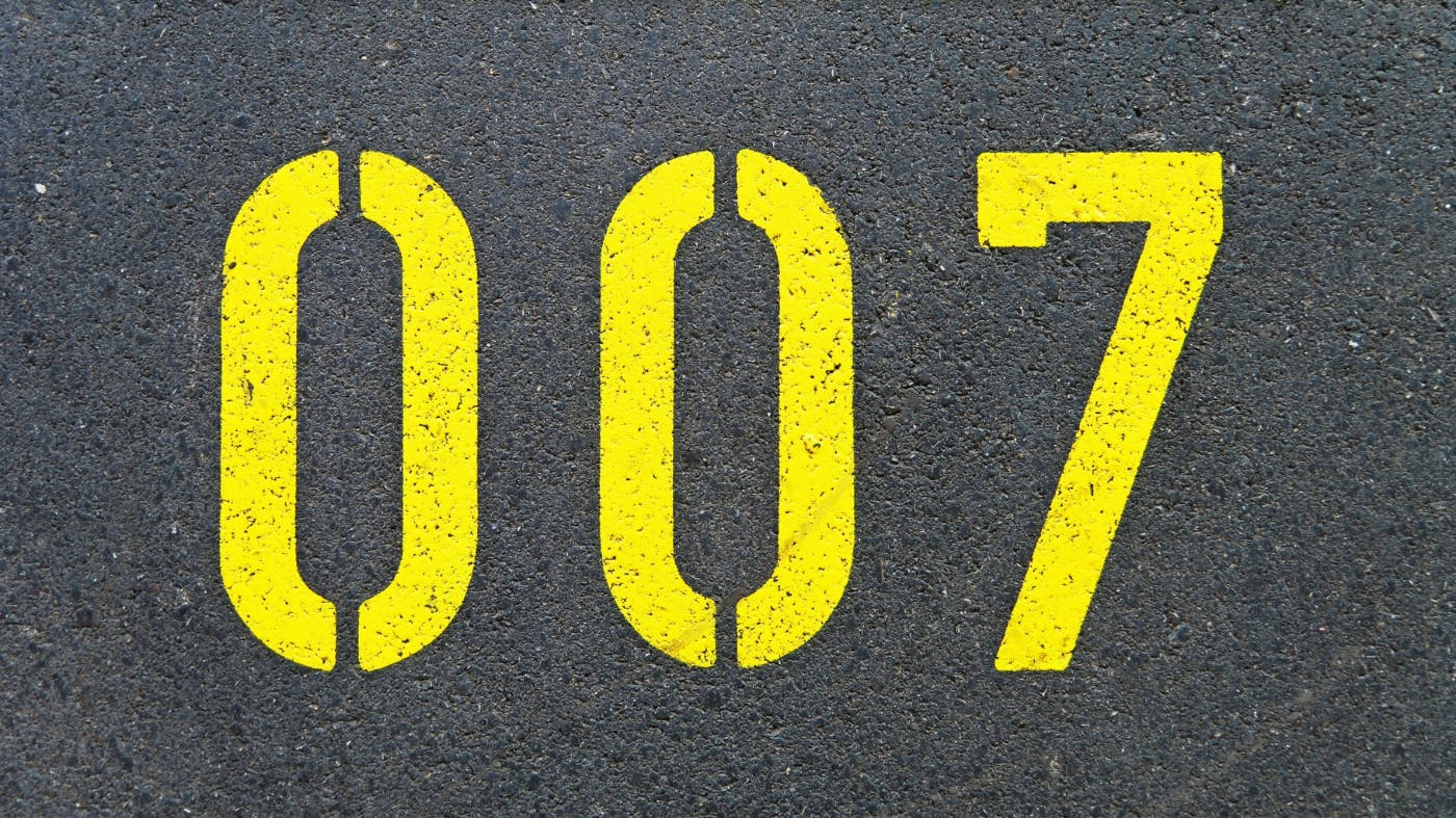 Double 0 7, painted in yellow block letters on a street