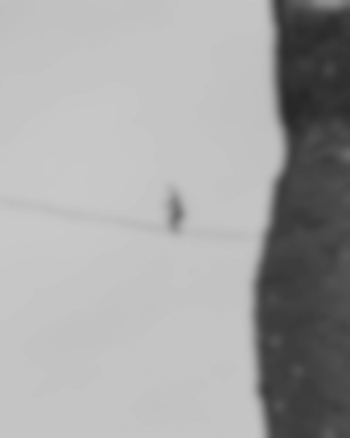 A man on a tightrope off a cliff