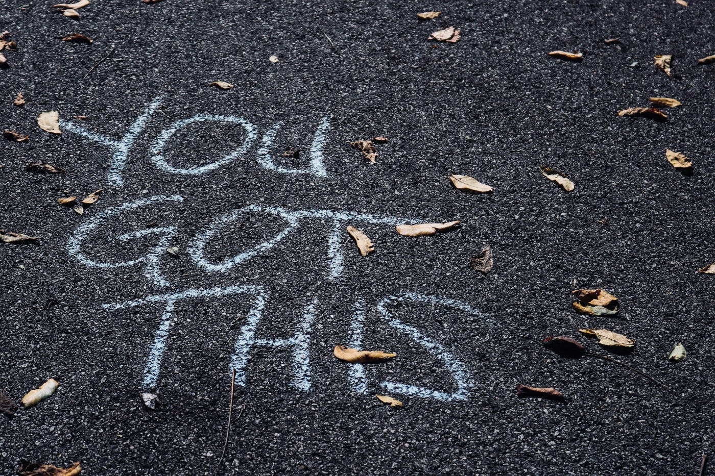 Chalk on a sidewalk reading: You Got This