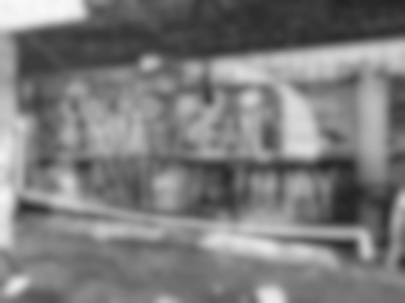 A gray scale image of a brick wall with graffiti reading: Words Do Not Mean Anything Today