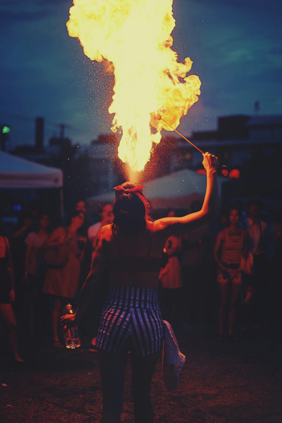A female fire eater at a night circus