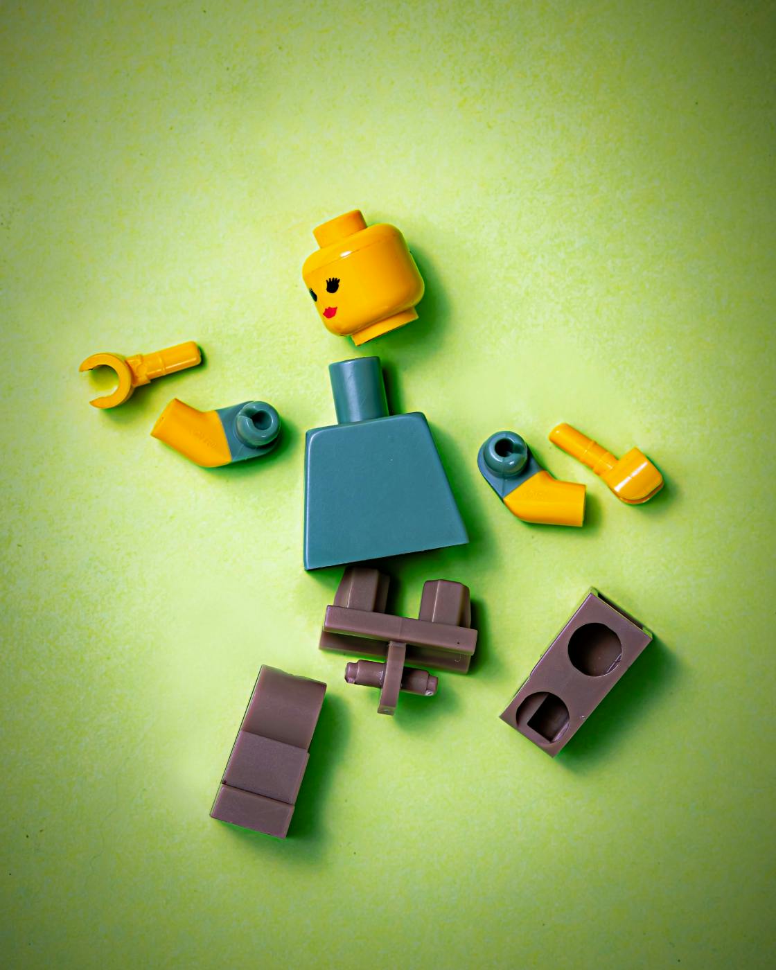 A Lego person in pieces