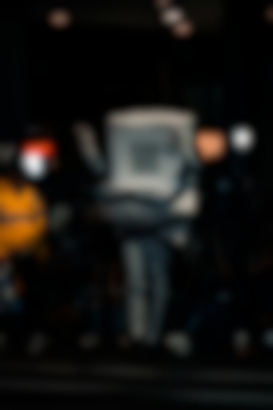 A person dressed as a toilet walking the street at night