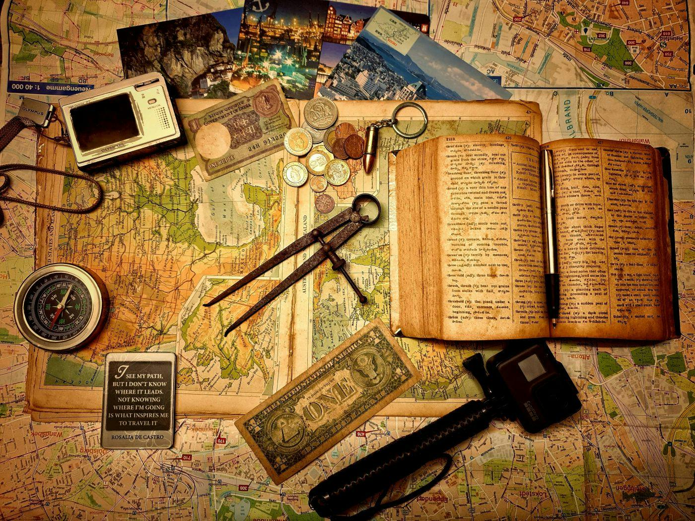 Map, books, coins, money all instruments of travel