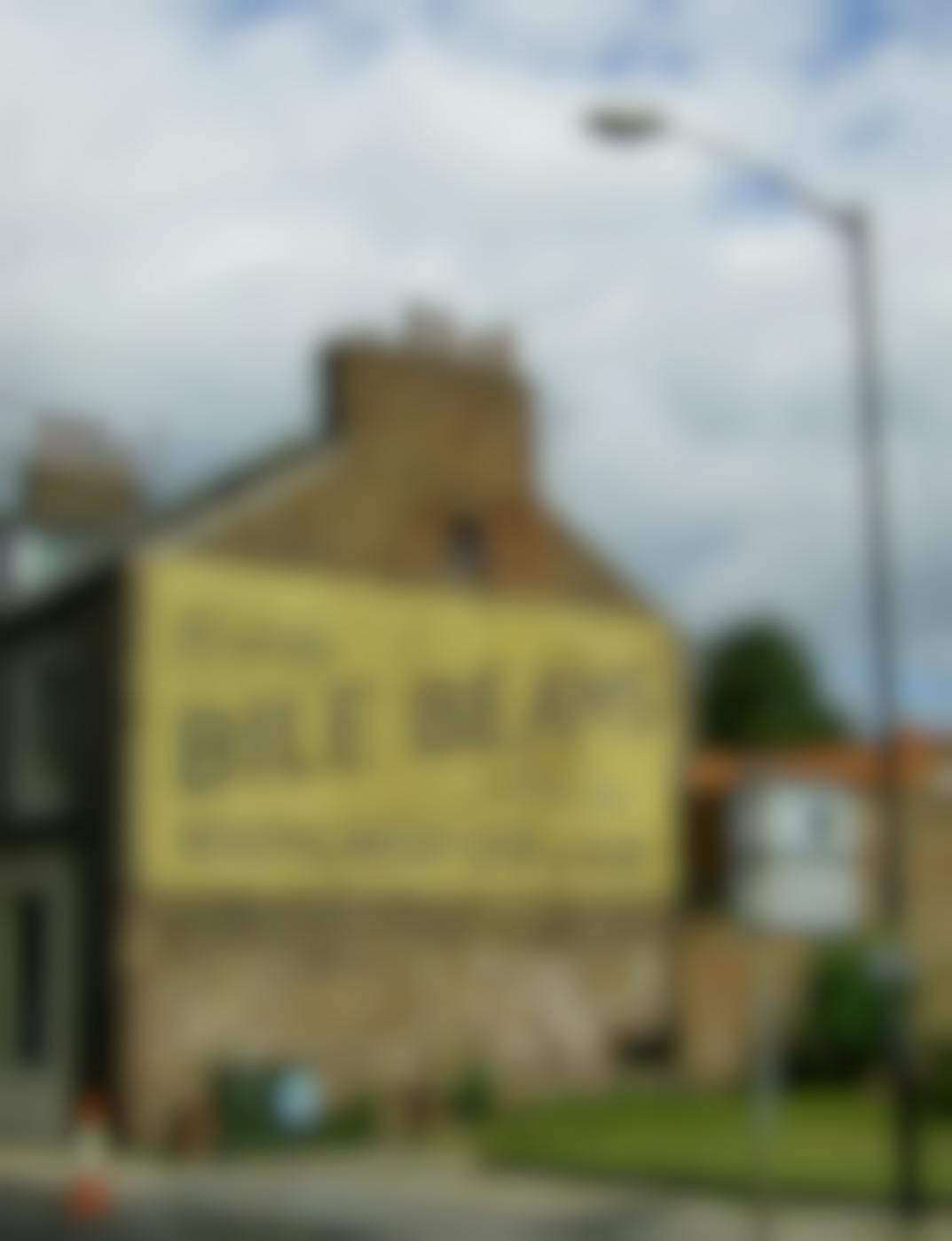 an ad on the side of a brick building for Bile Beans