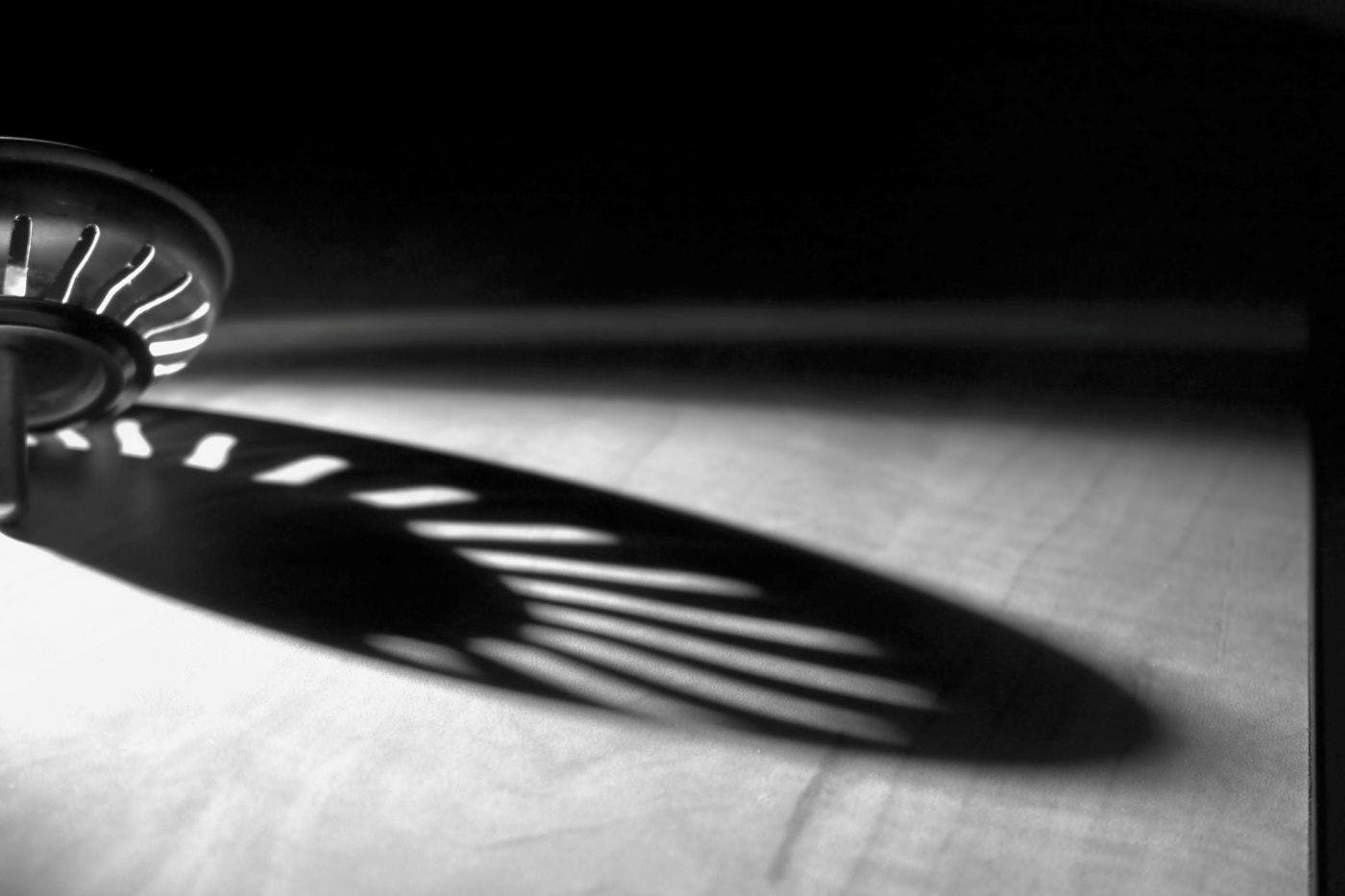 The reflection of a drain guard on a counter top