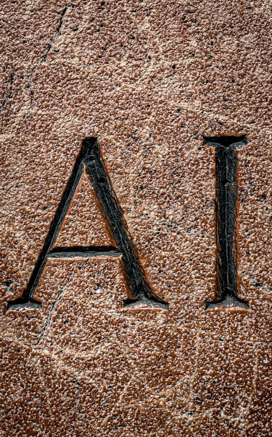 The letters A & I chiseled into red stone