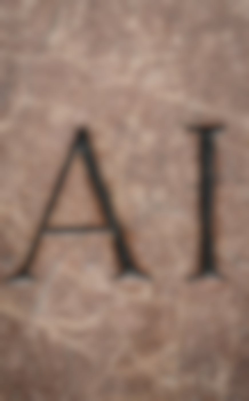 The letters A & I chiseled into red stone