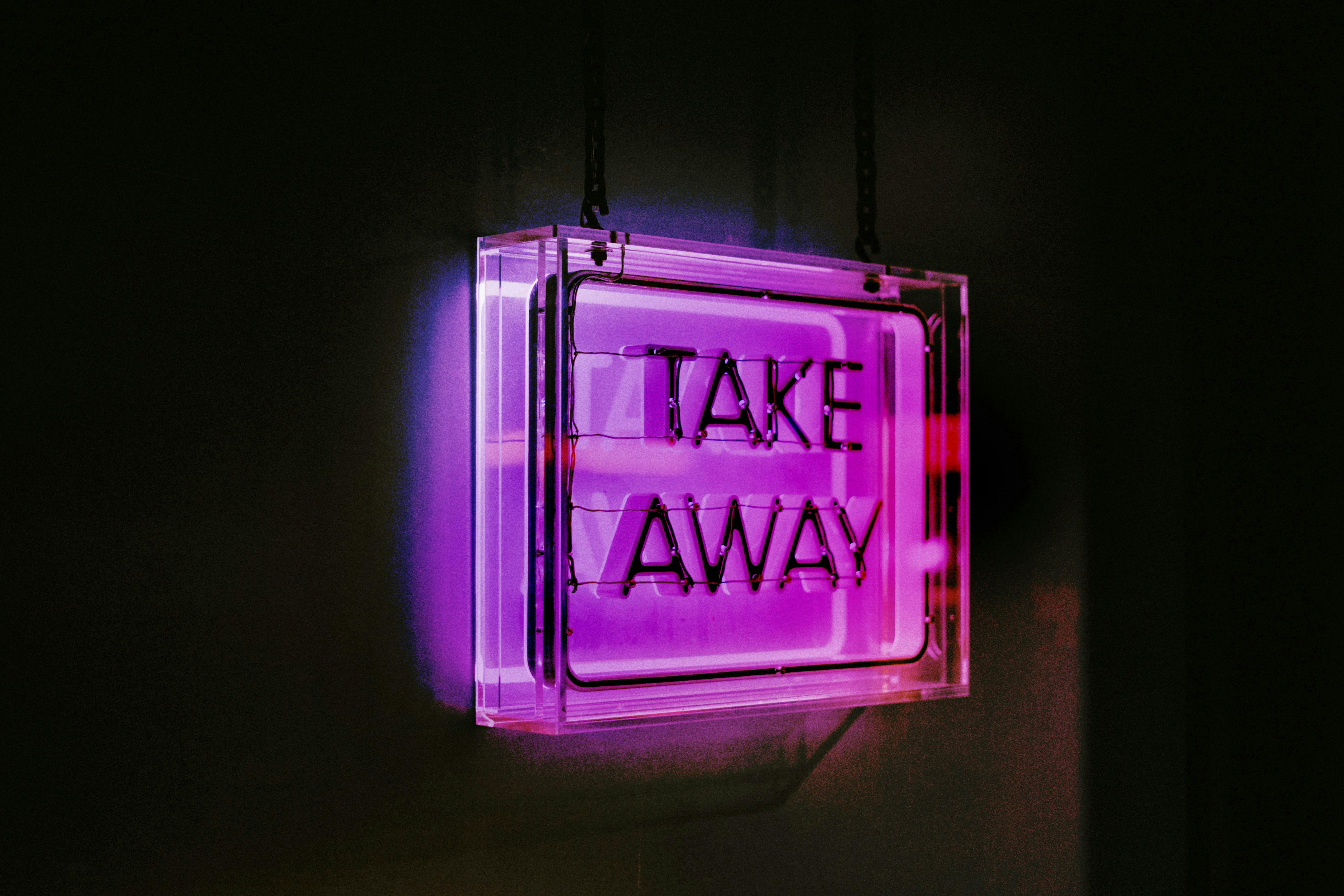 A purple neon take away sign