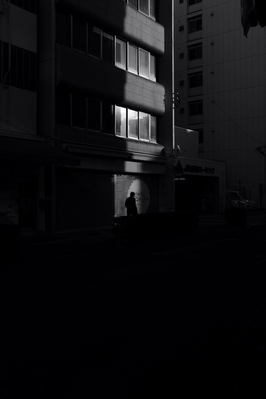 A solitary man waling the dark streets