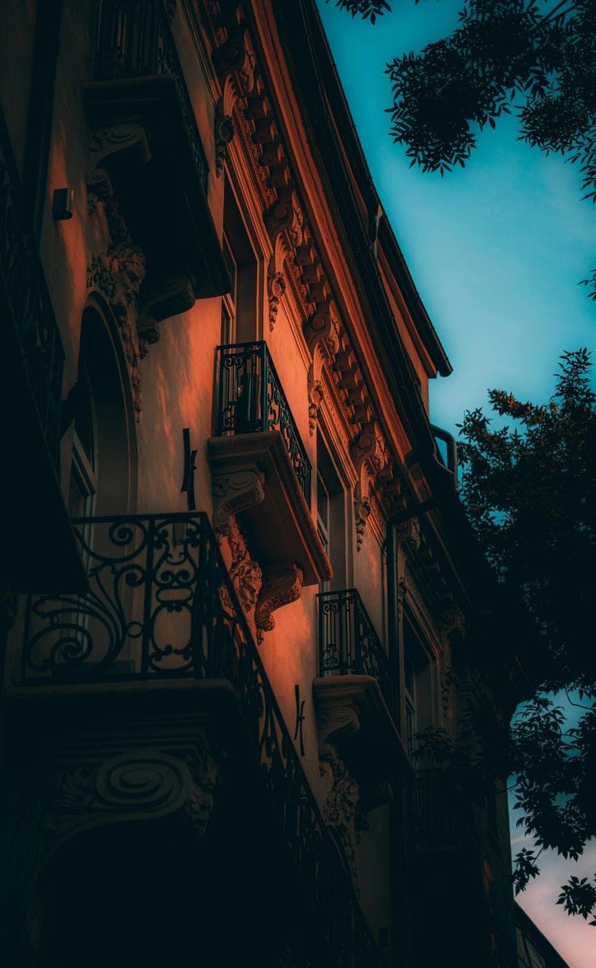 An old building with balconies in sunset