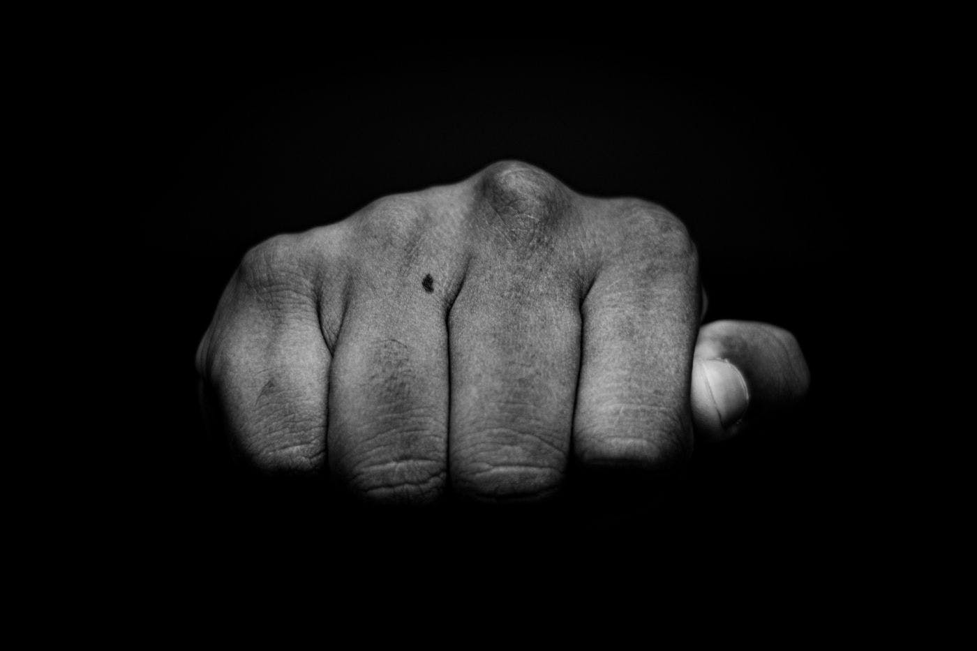 A single fist comin gout of the darkness