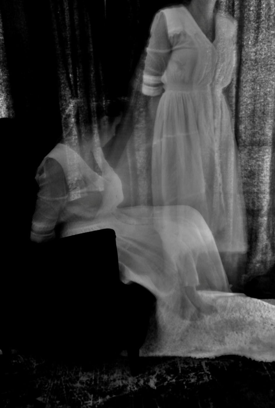 A black and white photo depicting a woman's soul leaving her body