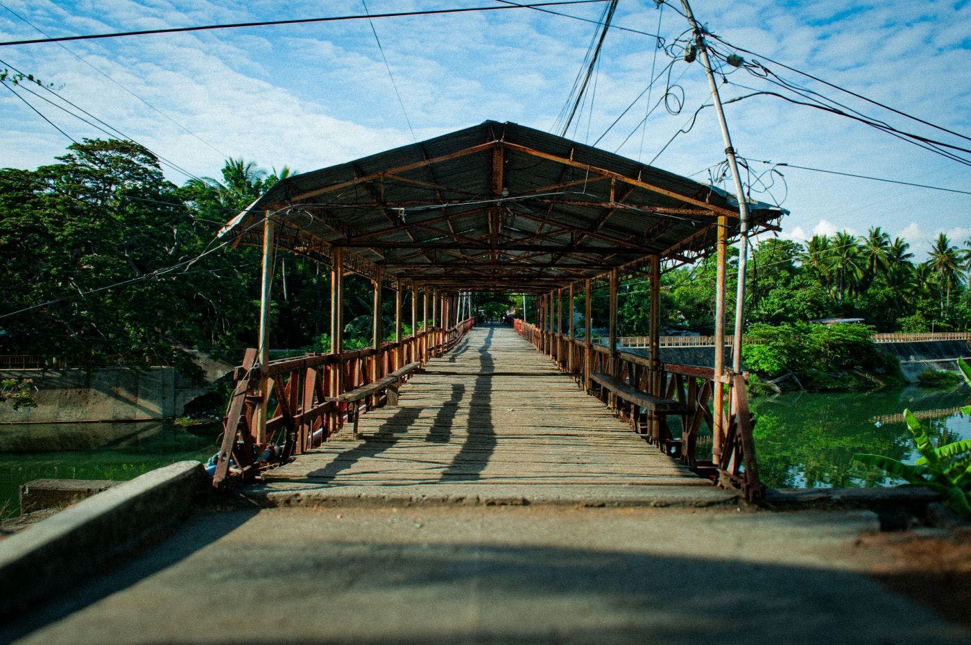A covered wooded bridge over a river