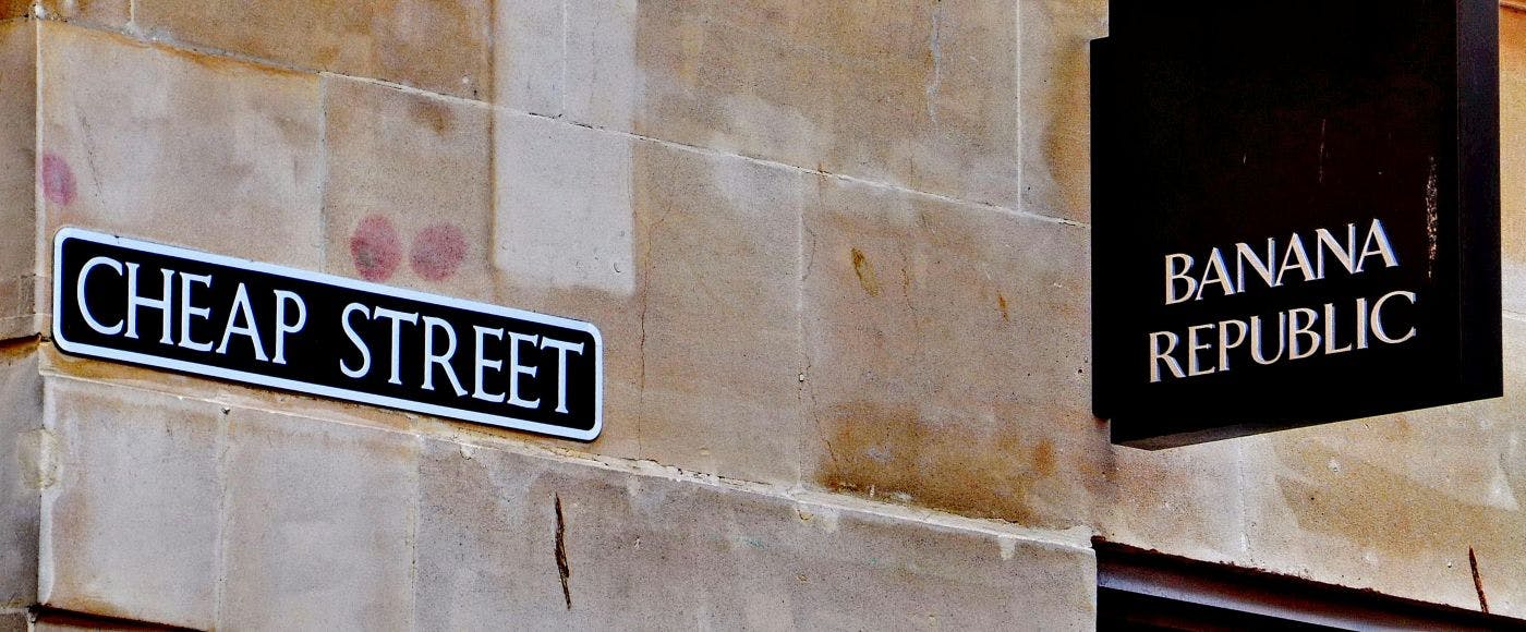 Street sign Cheap Street and a Banana Republic sign