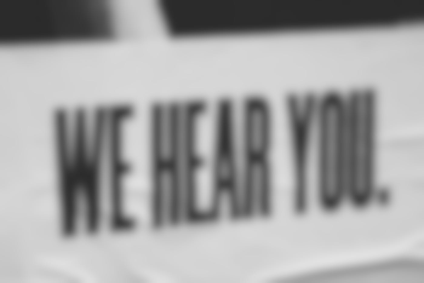 A sign that reads We Hear You