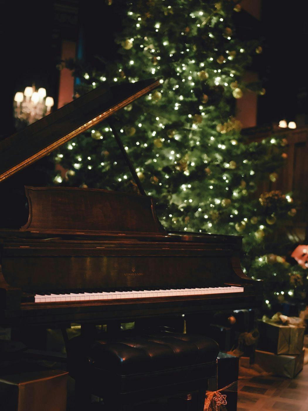 A piano by a Christmas tree