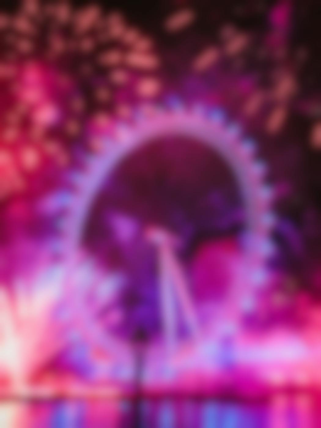 A Ferris wheel under fireworks