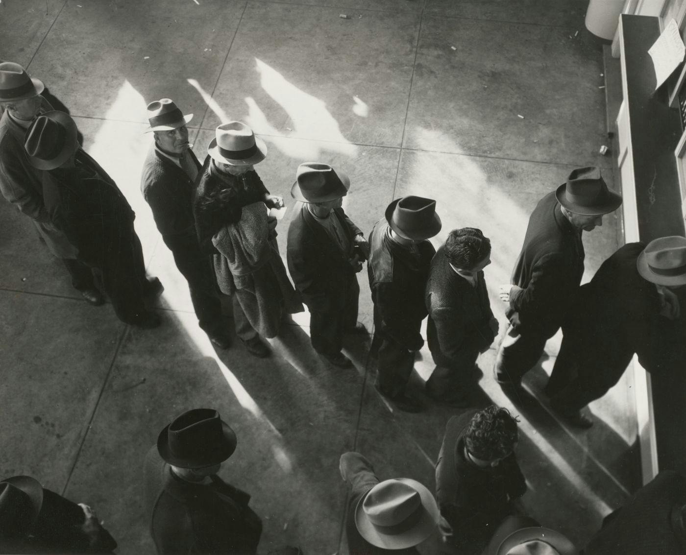 Black and white, people standing in line for a job circa 1940