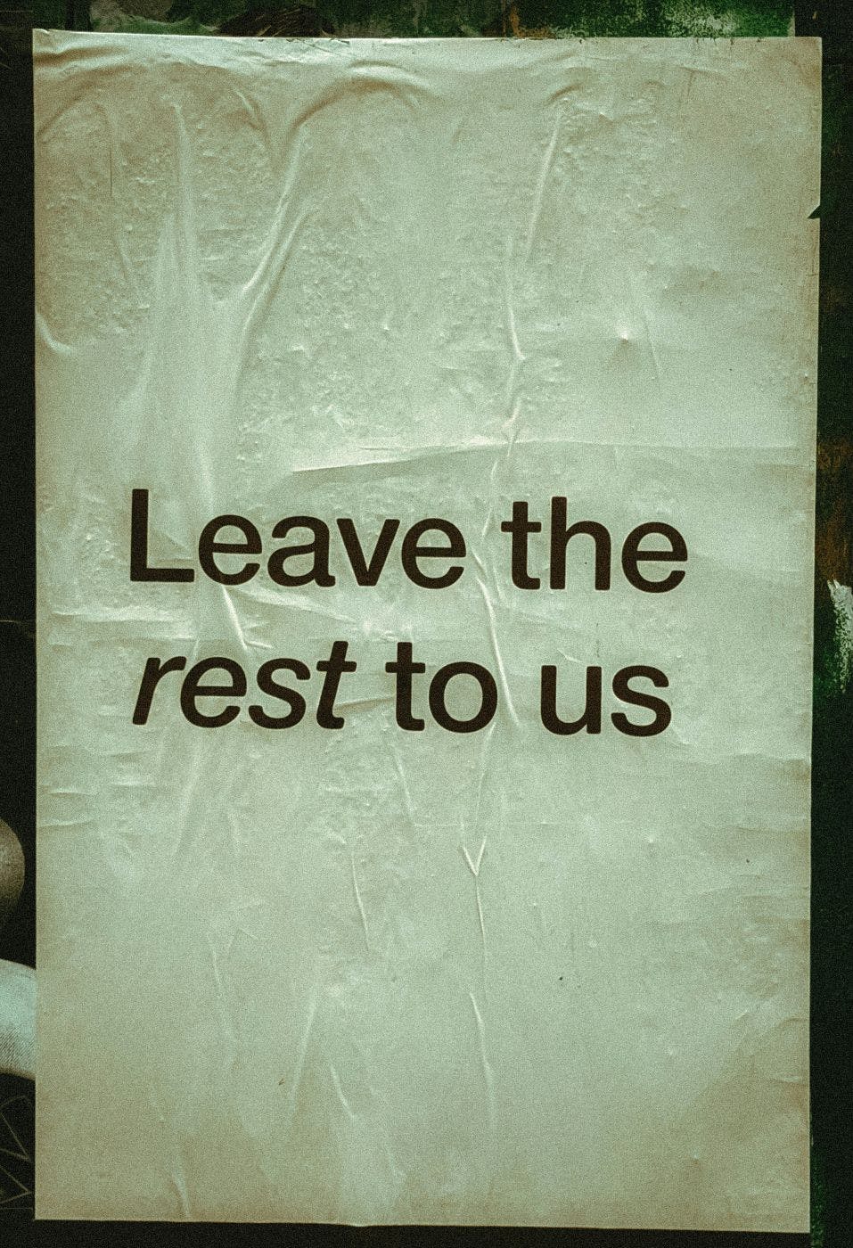 A sign in a window reading Leave the rest to us